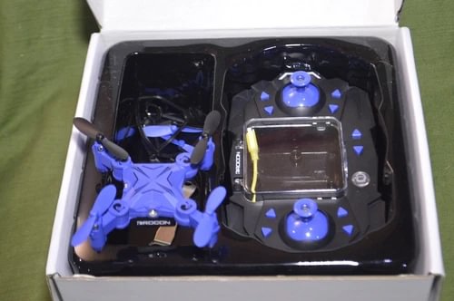Pocket drone with quadcopter and remote controller inside a storage box