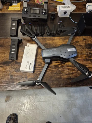 Used gray quadcopter drone with 4 propellers and remote controller