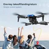 Folding RC quadcopter drone with dual camera and blue status lights