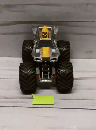Hot Wheels 1:64 diecast monster truck, front view with yellow and black details