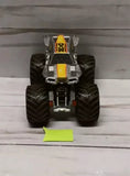 Hot Wheels 1:64 diecast monster truck, front view with yellow and black details