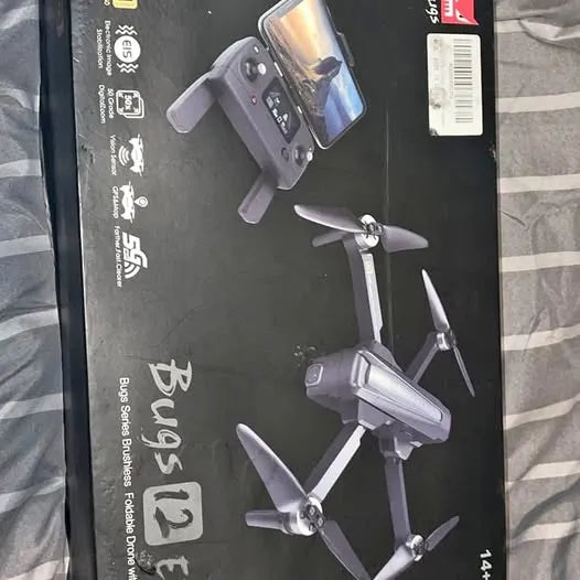 Foldable quadcopter drone with built-in camera and four propellers, gray body