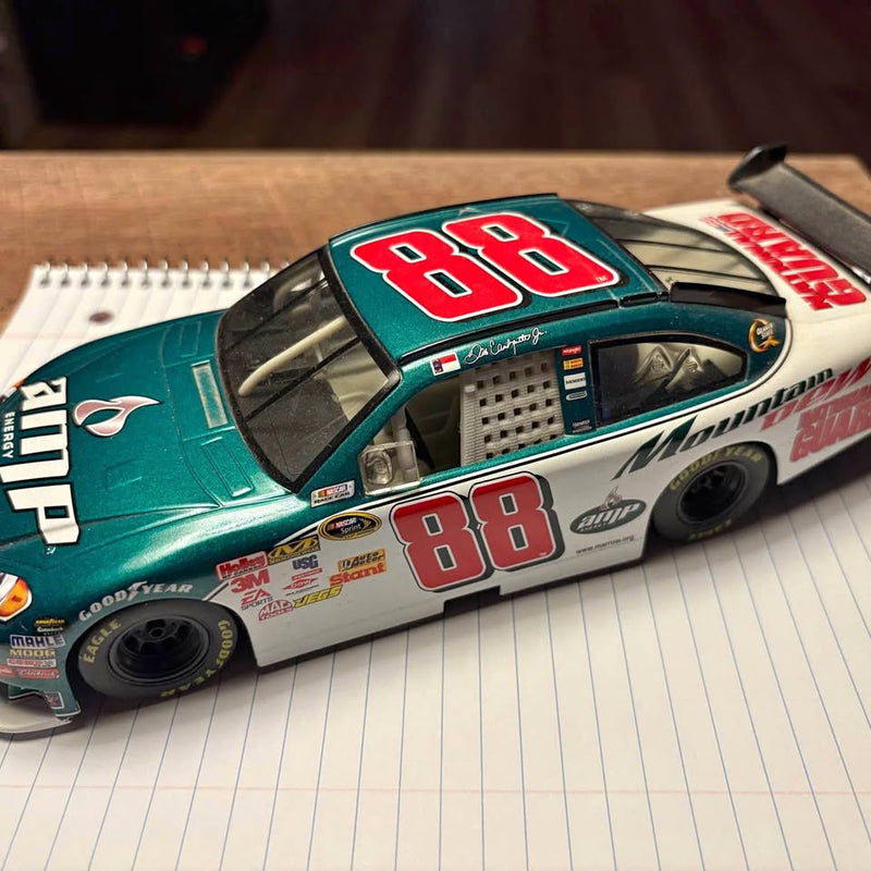 Diecast race car in teal and white with red 88 on hood and doors