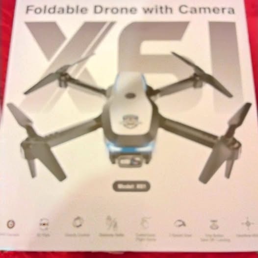 White foldable quadcopter drone with camera and four dark propellers