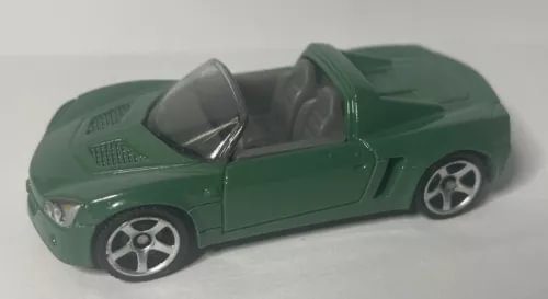 Green diecast toy sports car with black interior and silver-spoke wheels