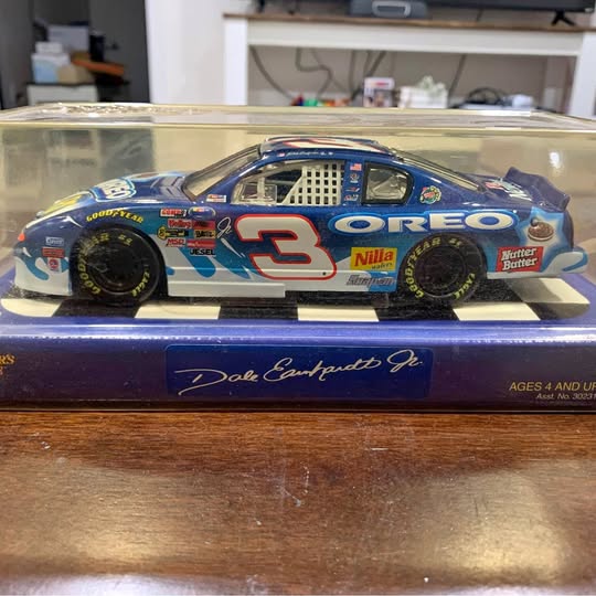 Blue diecast race car with #3 on doors, detailed sponsor decals, black wheels.