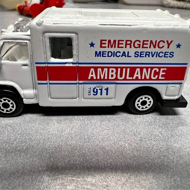 Die-cast ambulance toy with emergency medical services logo and 911, white and red stripes