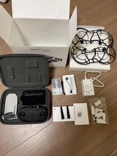 Camera drone with carrying case, prop guards, batteries and charging accessories