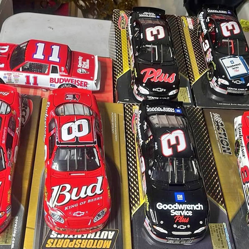 1/24 NASCAR diecast race cars, red and black models in retail boxes