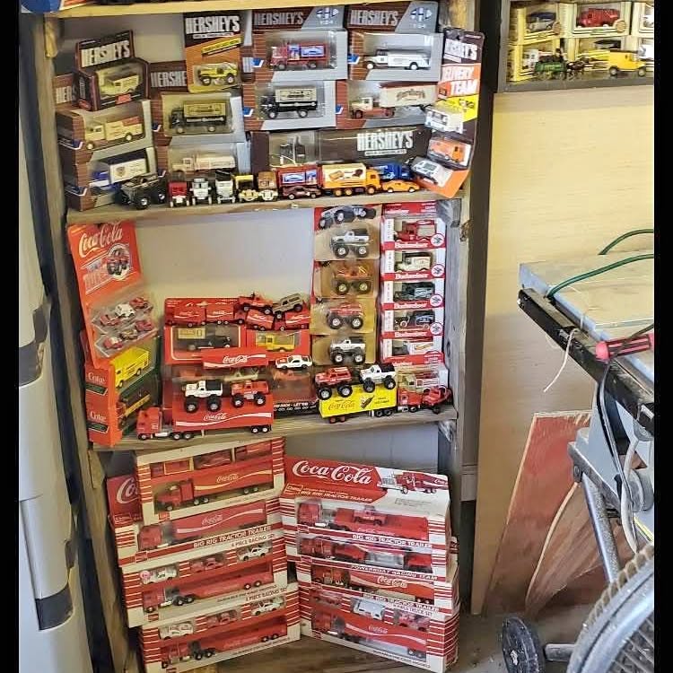 Vintage diecast truck toy display with boxed trucks and cars, red and multicolor