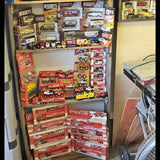 Vintage diecast truck toy display with boxed trucks and cars, red and multicolor