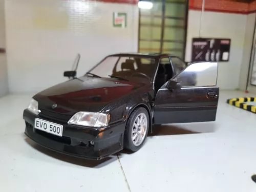 Black and red 1:24 diecast sports car model with front open door