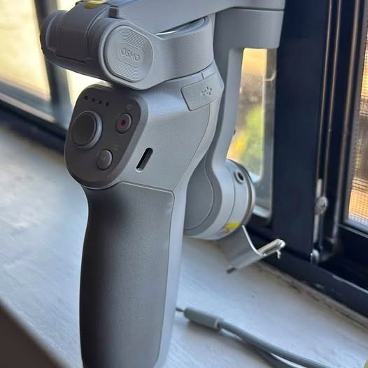 DJI OM 4 handheld 3-axis smartphone gimbal, gray body with joystick and buttons