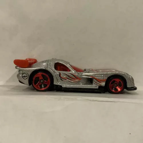 Metallic grey diecast race car with red accents and red wheels, side view.