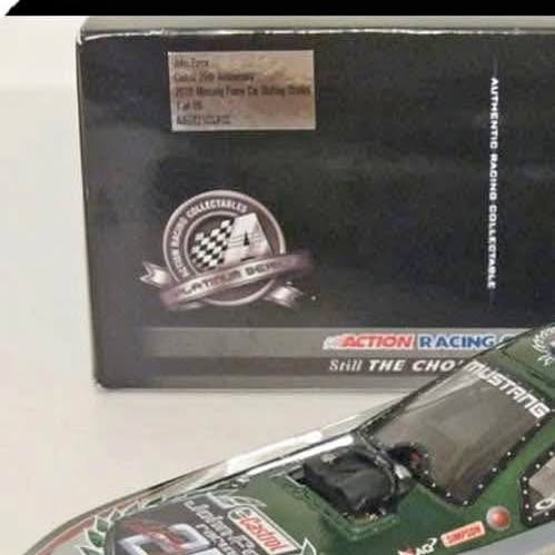 Green diecast racing car model in display packaging