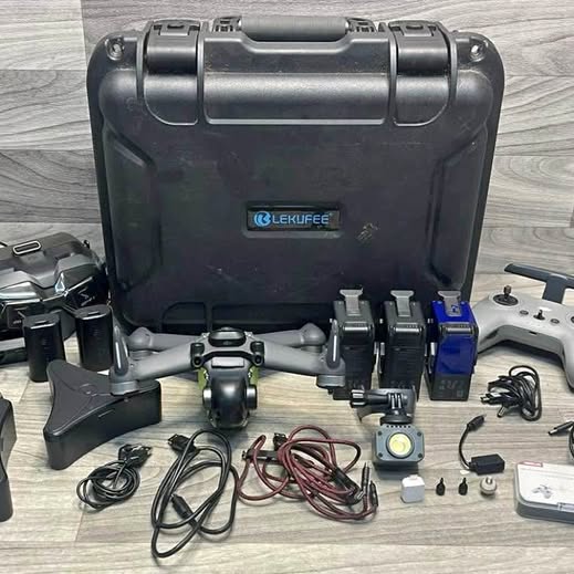 Drone accessory kit with hard transport case, controller, cables, and spare parts