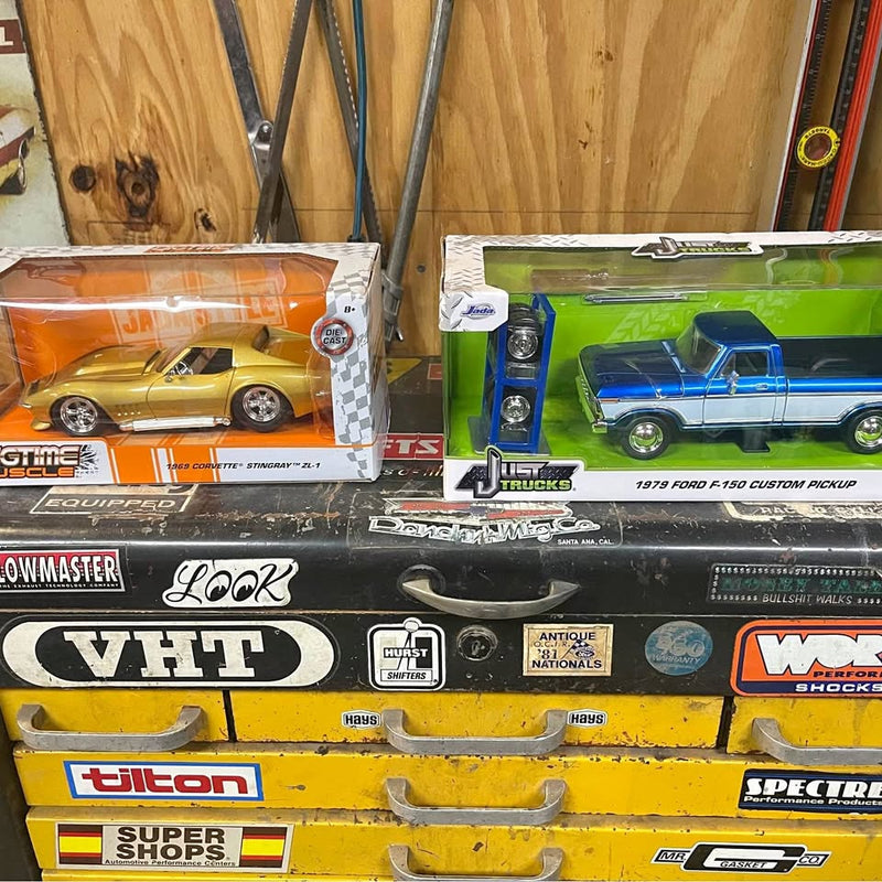 Diecast car boxes with yellow and blue pickup models, in clear blister packaging