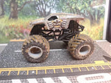 Monster Jam MAX-D mud-covered 1:64 diecast monster truck with oversized tires