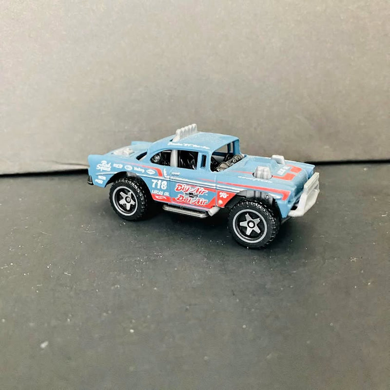 Light blue and red diecast pickup-style model car with black wheels, front 3/4 view.