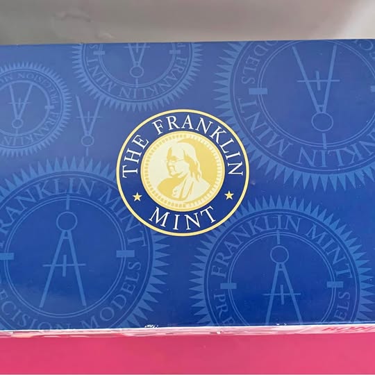 Diecast metal car box with blue logo panel and gold THE FRANKLIN MINT emblem