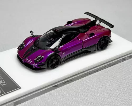 Purple and black racing sports diecast model car with rear wing, front 3/4 view