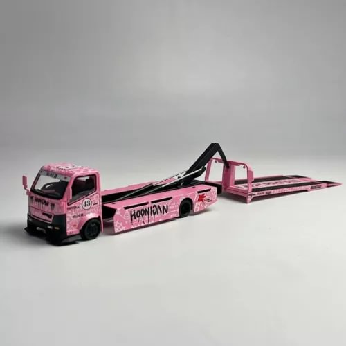 Pink diecast tow truck model with raised flatbed and black ramp