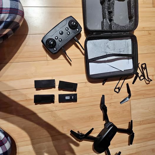 Beginner drone kit with remote controller, foldable quadcopter, and carrying case