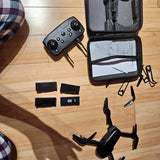 Beginner drone kit with remote controller, foldable quadcopter, and carrying case