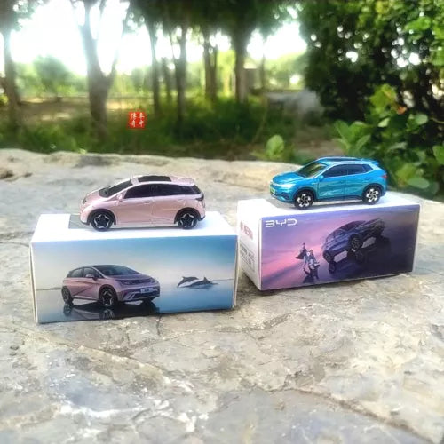 Diecast model car set with two boxed cars: blue and pink