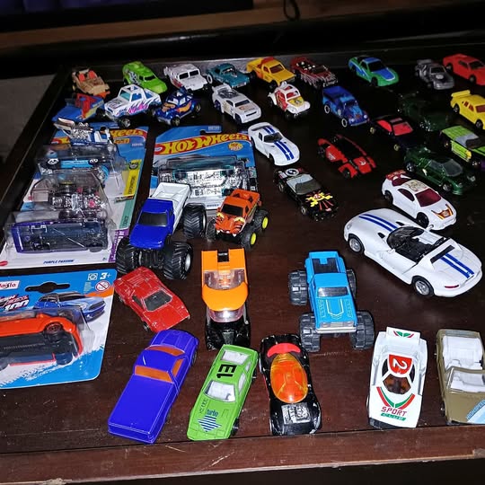 Diecast toy car assortment in a display tray with multiple colorful vehicles