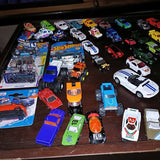 Diecast toy car assortment in a display tray with multiple colorful vehicles