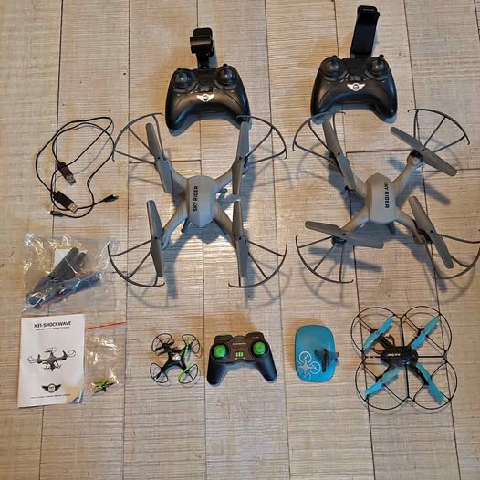 Quadcopter drone set with four drones, two controllers, and camera modules