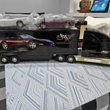 Diecast truck in display box, black with gold trim and car graphics on front