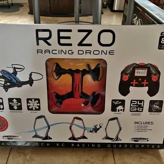 Racing quadcopter drone package with red controller and drone illustration on box