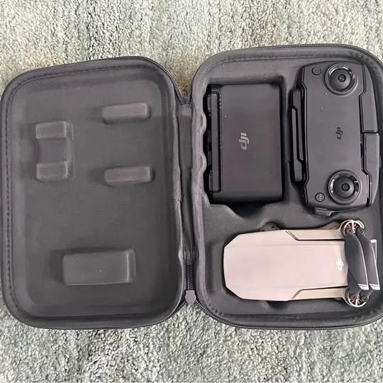 Hard-shell drone case with open compartments and controller remote inside
