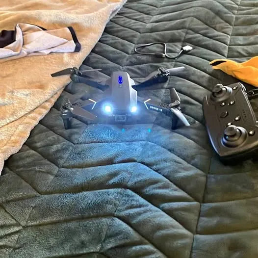 Quadcopter drone with four propellers and blue LED lights on fabric mat