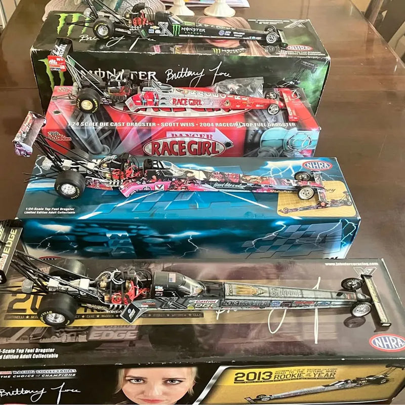 Diecast race car toy in retail box, multicolor Monster-themed graphics