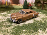 Weathered 1/64 diecast project car, rusty brown with open grille and chrome bumper