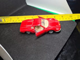 Maisto Ferrari Dino 246 GT 1:36 diecast car, red with open cockpit detail.