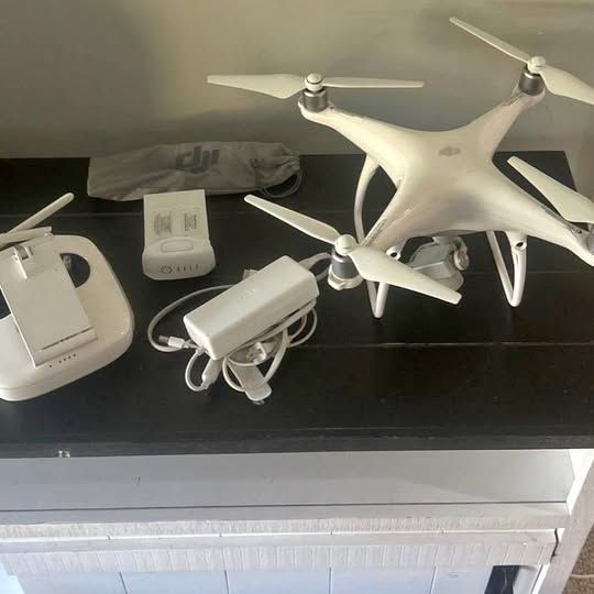 Dji Phantom drone with four propellers, white body