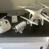 Dji Phantom drone with four propellers, white body