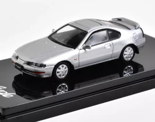 Silver coupe diecast metal model car with black base, 1:64 scale