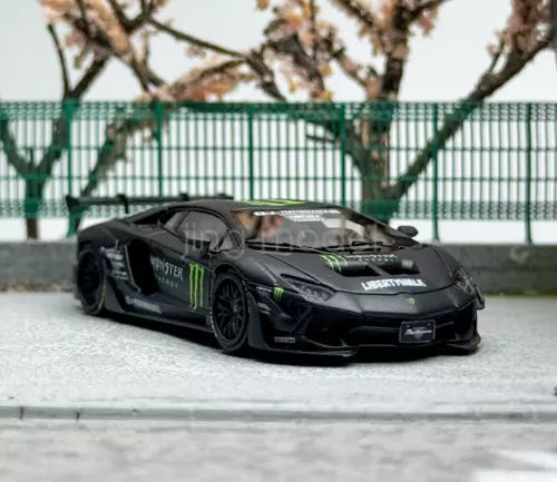 Black sports car model diecast with green racing stripes, front 3/4 view