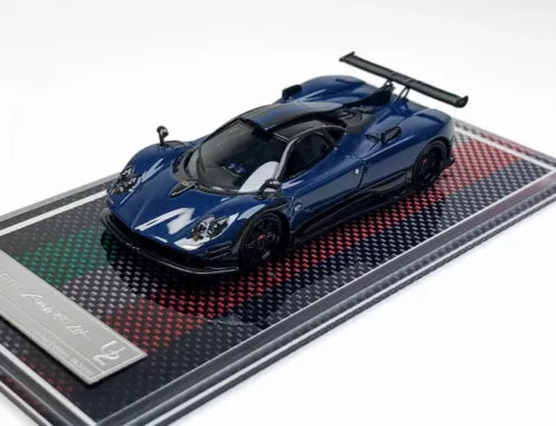 Blue racing sports diecast model car on black display base with red pattern