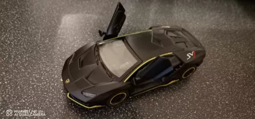 Alloy sport car model toy in dark gray with yellow accents, side view