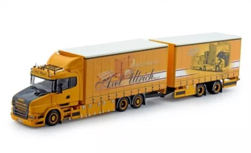 Orange diecast tractor unit truck with long box trailer, front grille and cab visible