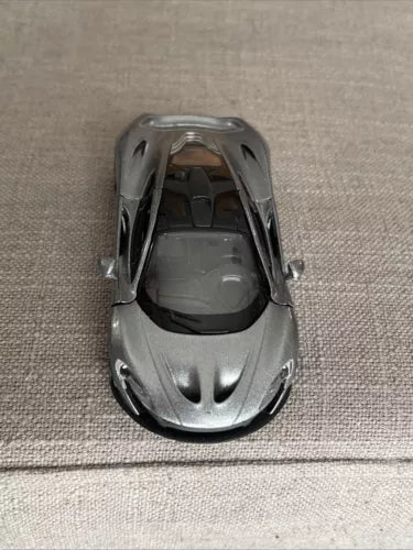 McLaren P1 silver diecast toy car with open cockpit detail, front view