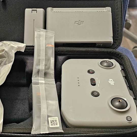 White drone remote controller with joysticks in protective hard case