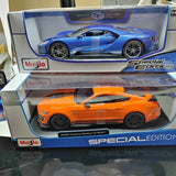 Orange 1/18th diecast model car with black wheels, shown in box