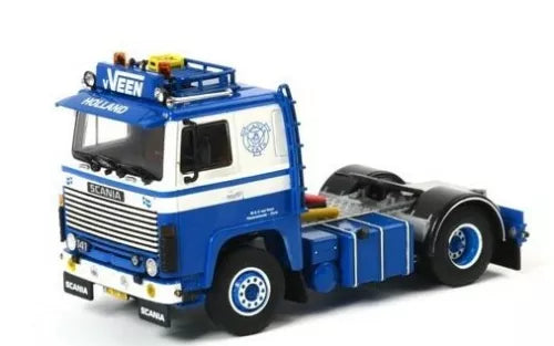 Blue and white diecast model truck with cab and front grille, front-side view